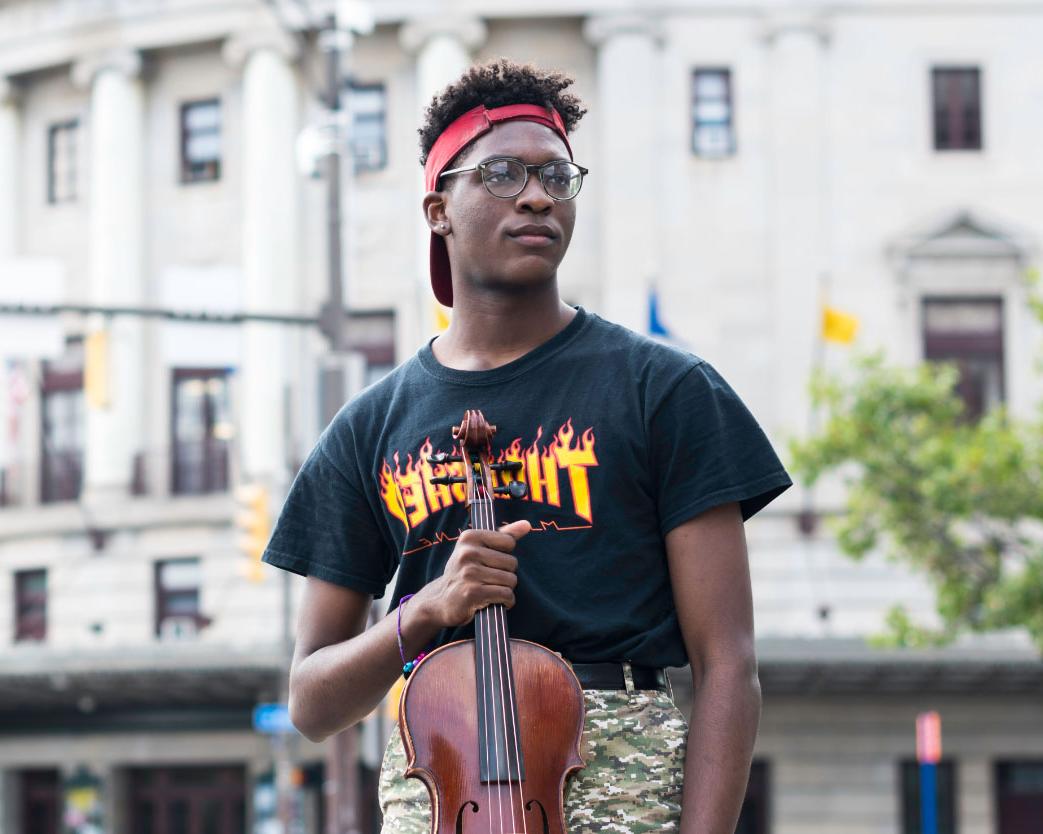 Student plays instrument on stage